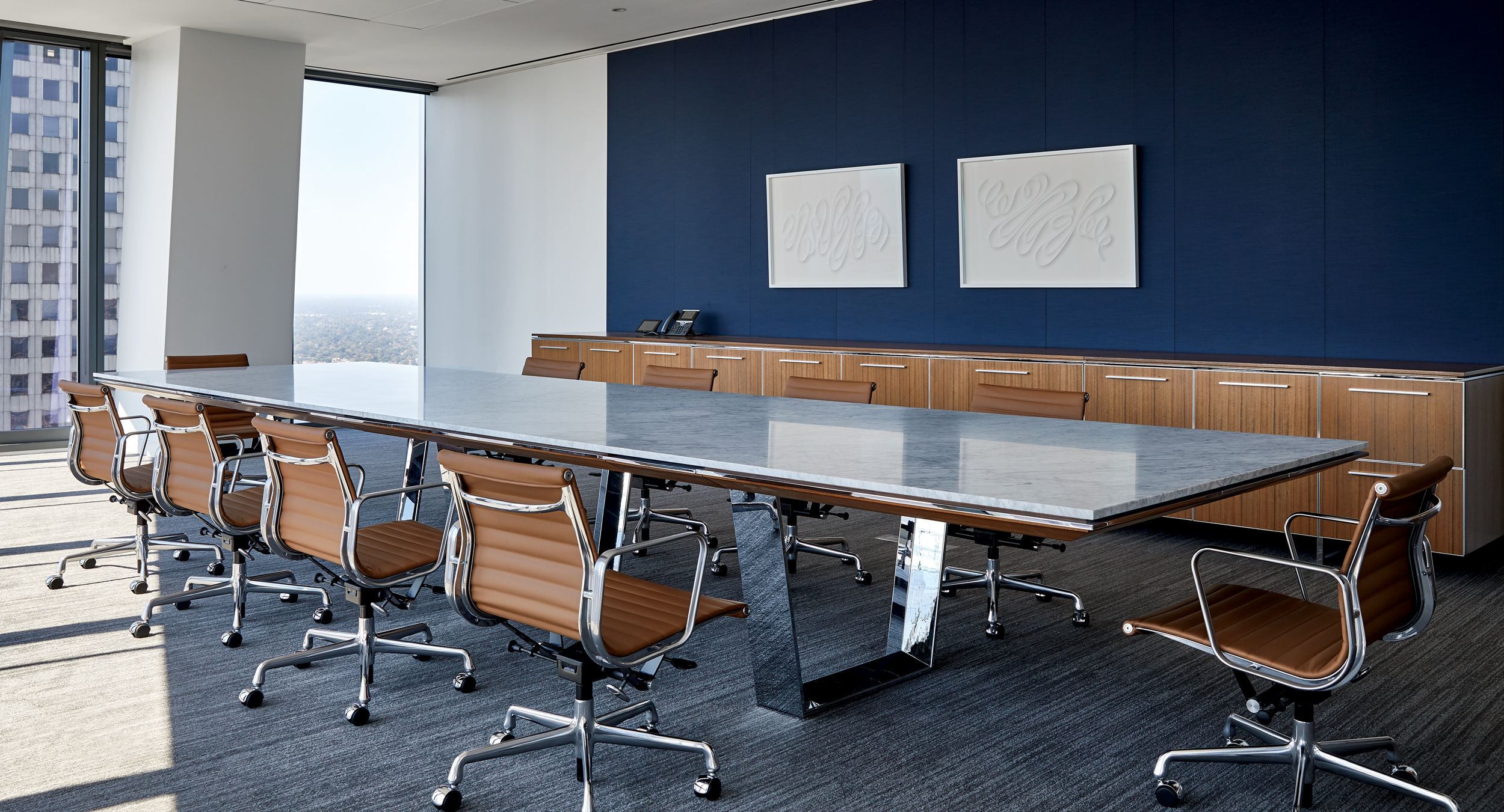 A stunning MESA conference table with storage credenza in Quarter Cut Paldao.